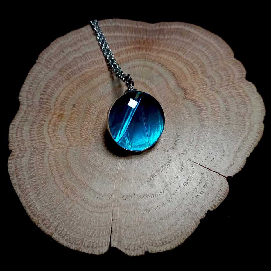Morpho menelaus butterfly wing preserved in a round glass lens necklace