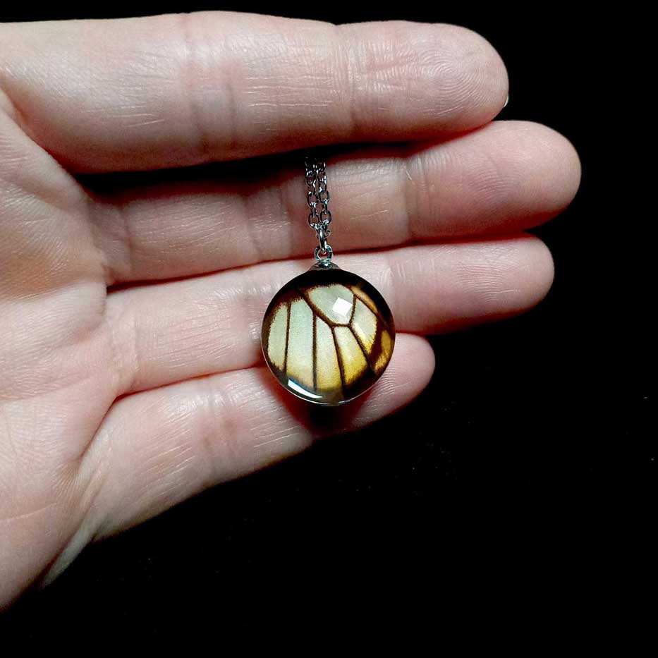 eurytides dolicaon butterfly wing necklace on hand